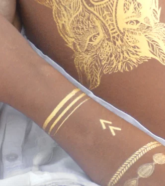 custom gold tattoos on arm