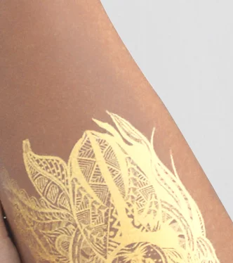 custom gold tattoos on leg